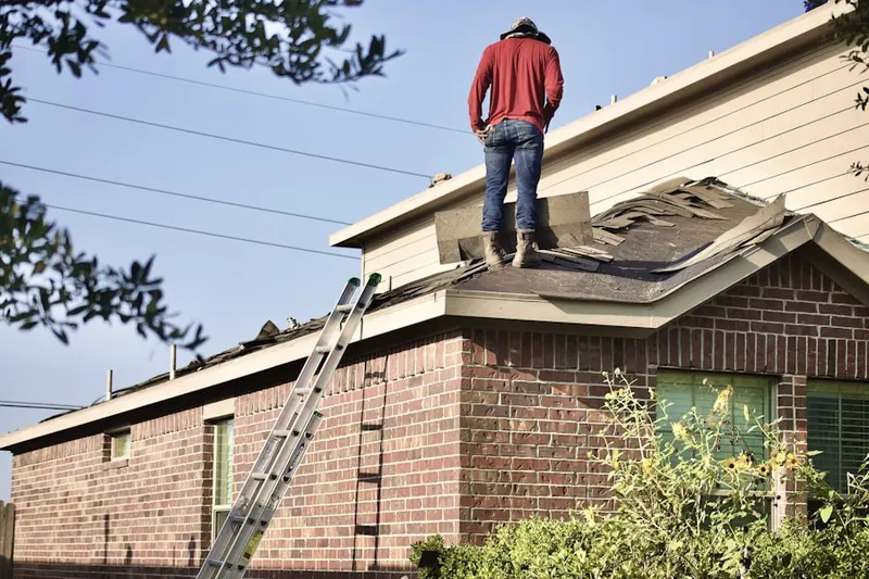 Professional roofer working on a residential roof in Harmans